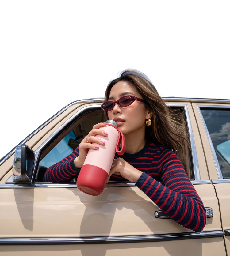Sipping from a pink bottle on the road